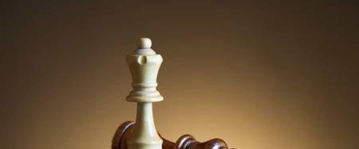 70439038-white-queen-defeats-king-in-chess-game-a-symbol-of-victory-on-the-chessboard-wooden-chess-figures-on-1
